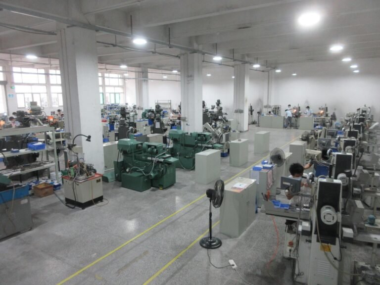The machine floor from one end, a row of grinding machines running down the bay